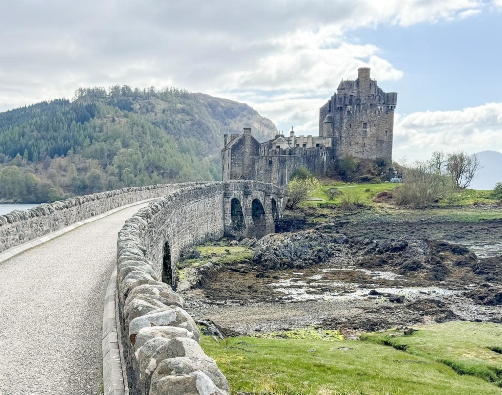 Stone bridge leading to the isolated Eilean Donan Castle, Highlands, Scotland.