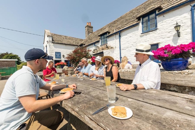 Enjoying pasties at the Square and Compass, Swanage, England.