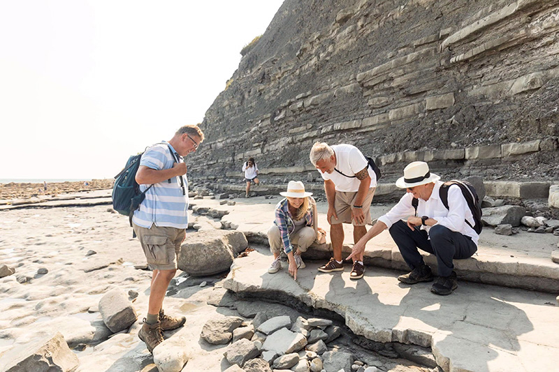 Fossil hunting at the beach at Lyme Regis, Dorset, England.