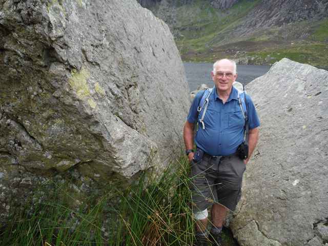 Tour guide and Darwin detective, Michael Roberts in Wales. Tour guide and Darwin detective Michael Roberts stands amongst huge boulders with his hands in his pockets.